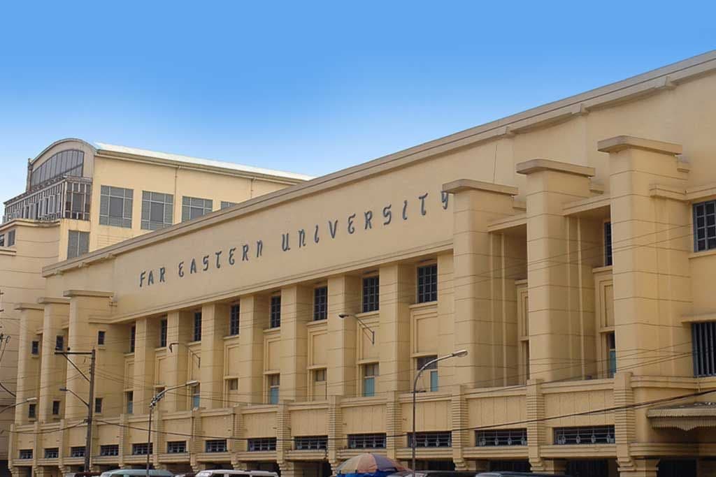 An Art Deco building with "FAR EASTERN UNIVERSITY" inscribed on its beige facade.