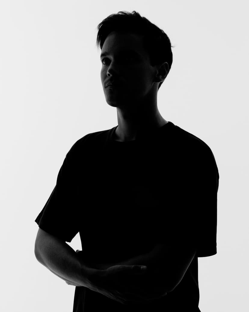 Silhouette of a young man with short hair wearing a t-shirt, looking to the side.