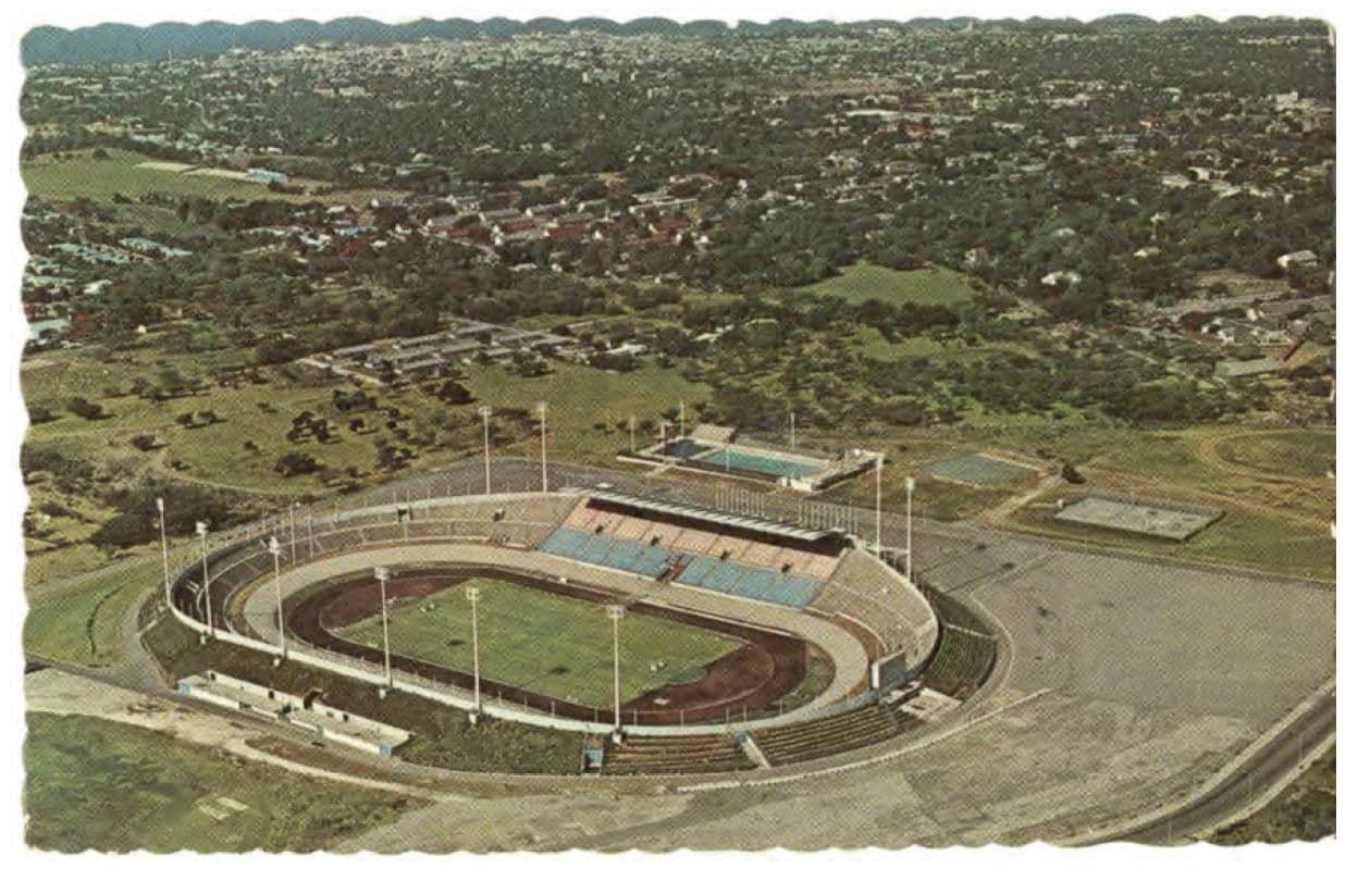 Aerial view of a large oval stadium with a track and field inside.