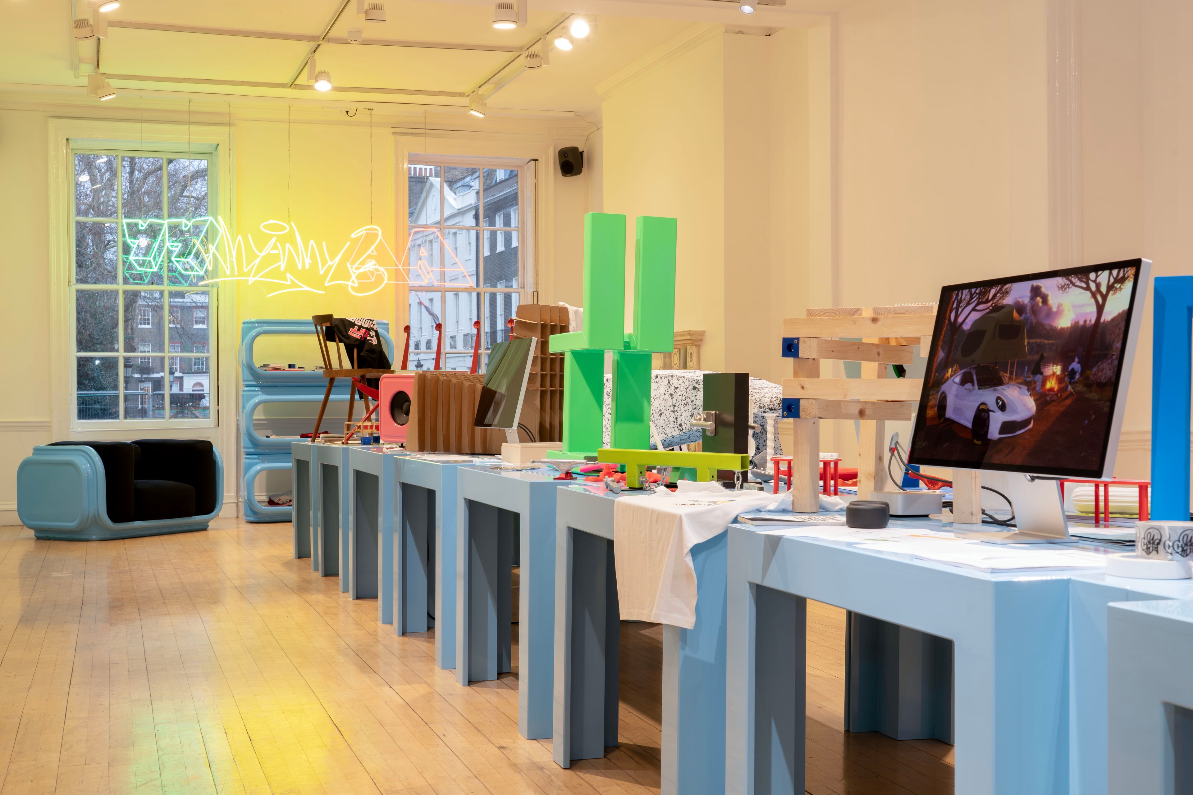 Photograph of a room with a blue table with objects on top