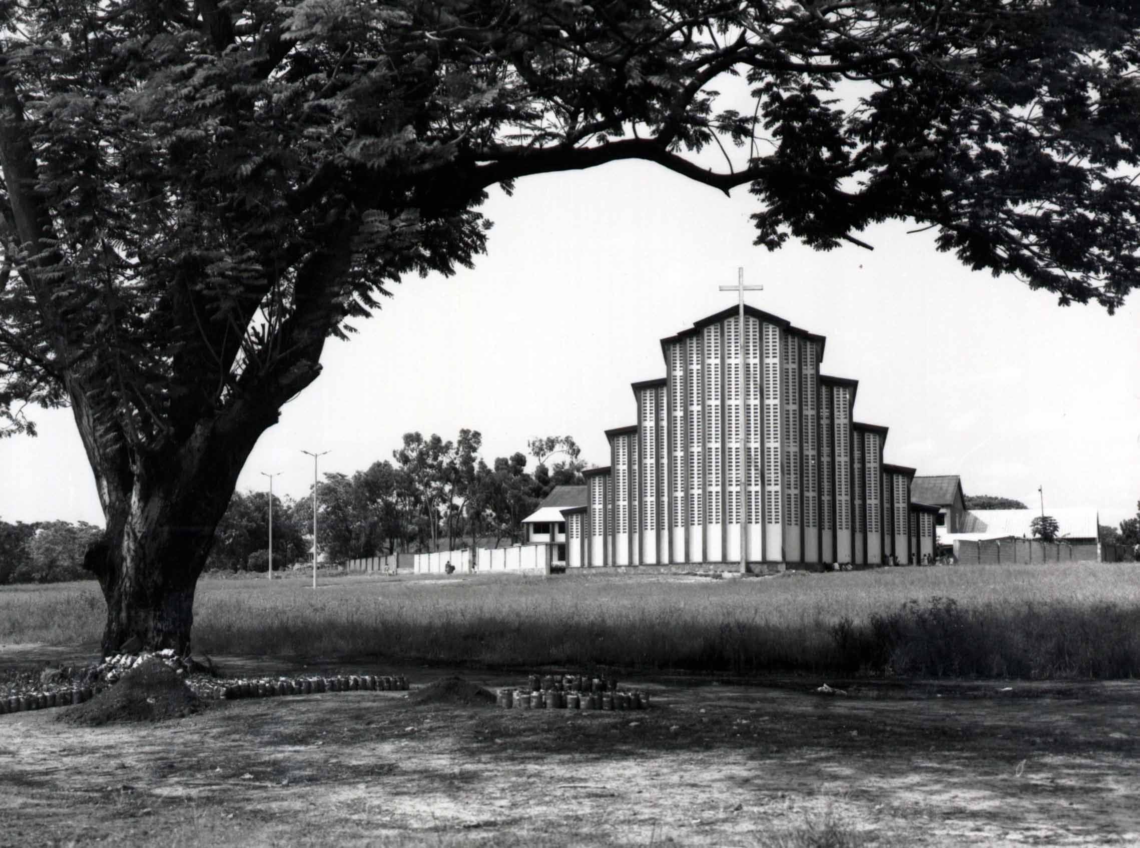 A large, modern-style church with a distinctive stepped facade and a cross atop its roof.