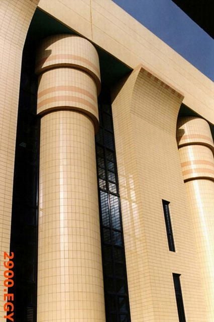 Cream-colored ribbed columns and flat architectural elements on a building facade.