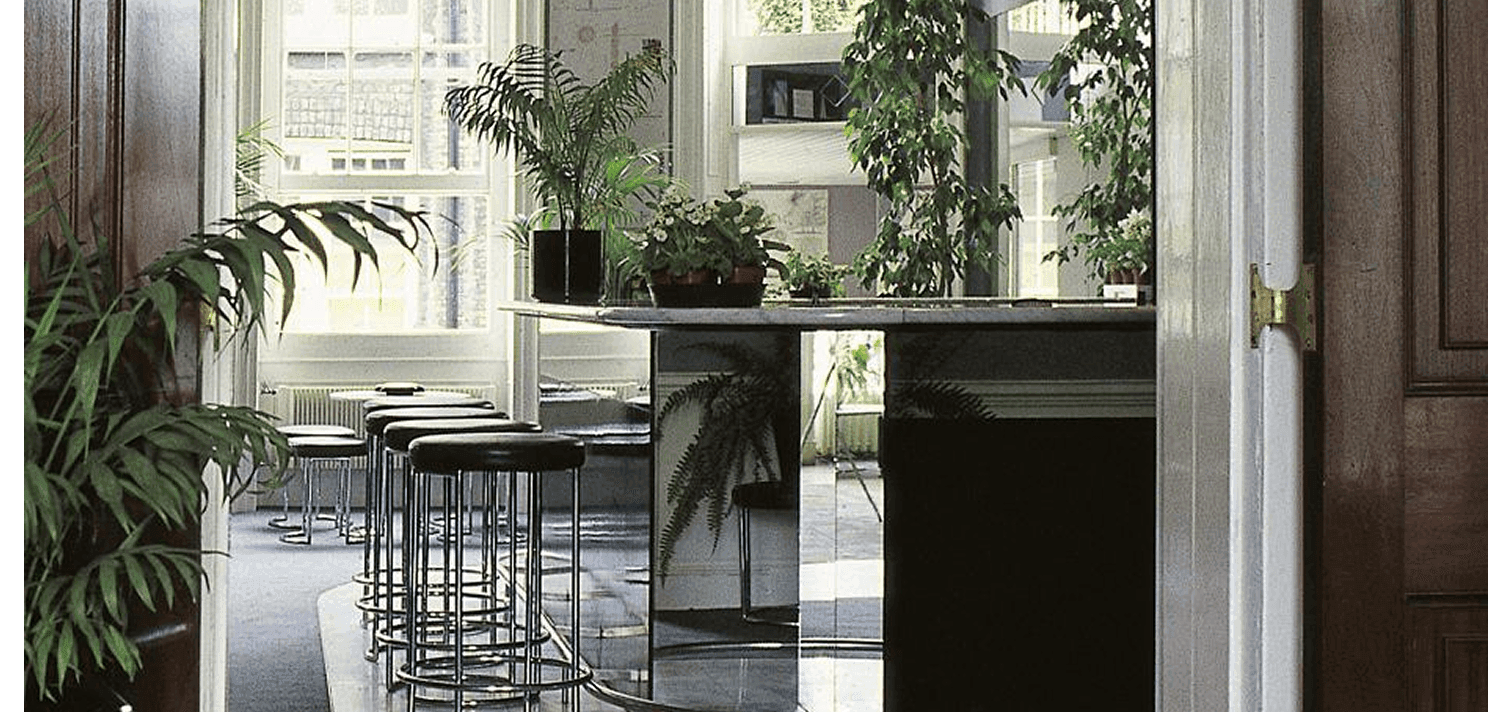 a top-down photo of a bar with tables and chairs and crowds of people.