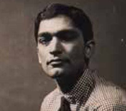 Monochrome portrait of a young man with dark hair, wearing a shirt and tie.