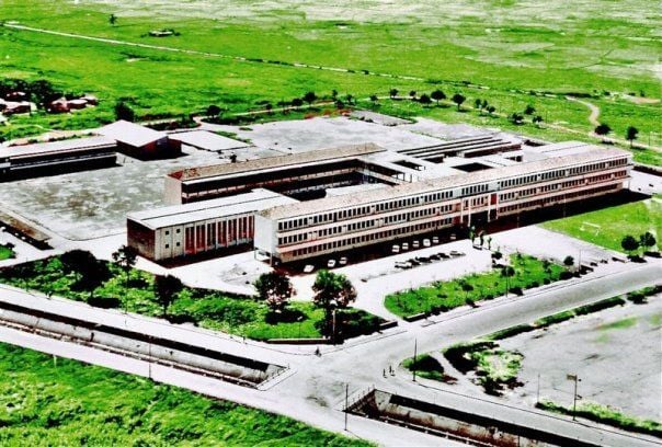 Aerial view of a sprawling, multi-building educational institution with U-shaped courtyards.