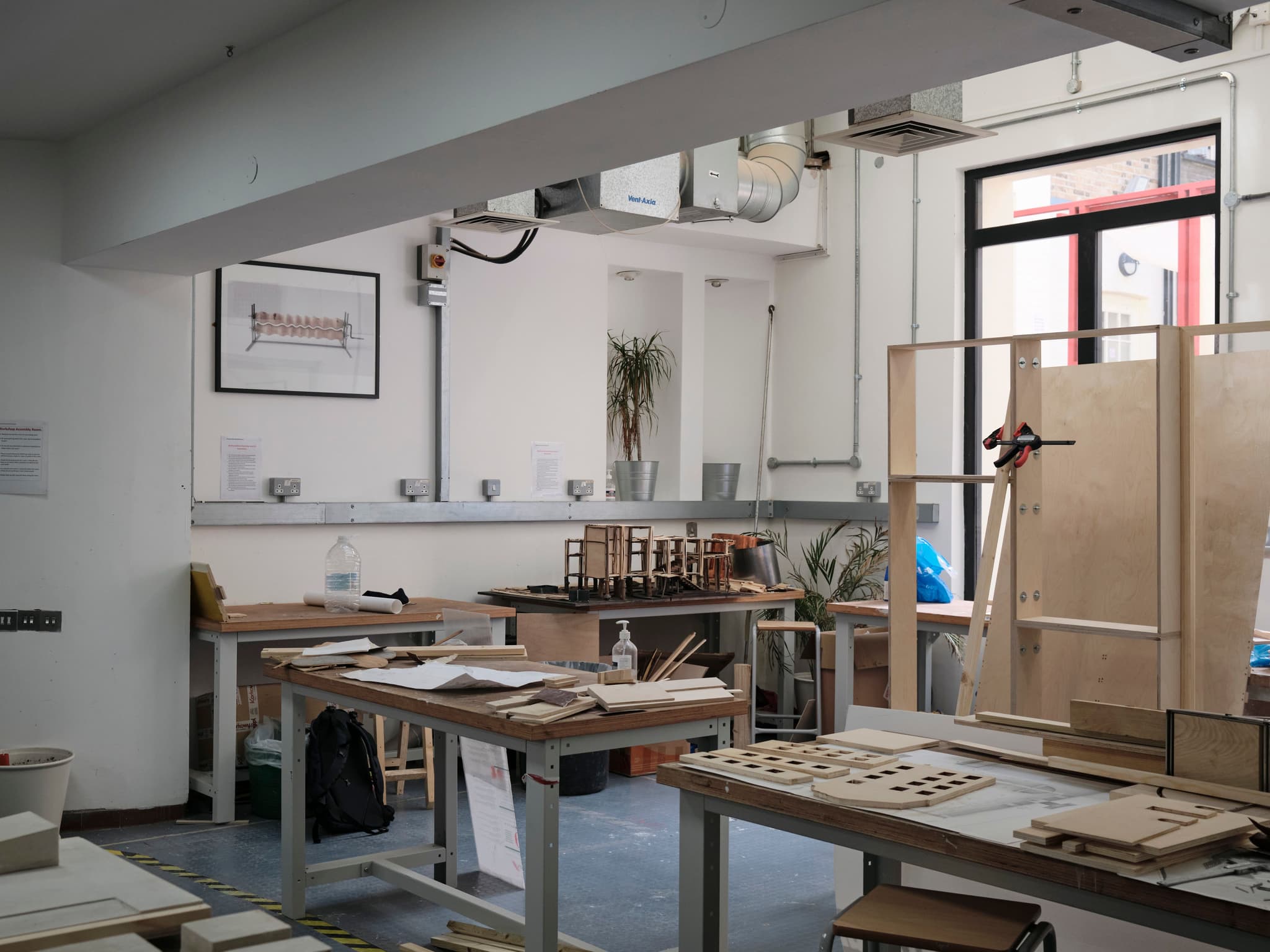 A well-lit workshop with workbenches, tools, and materials for crafting.