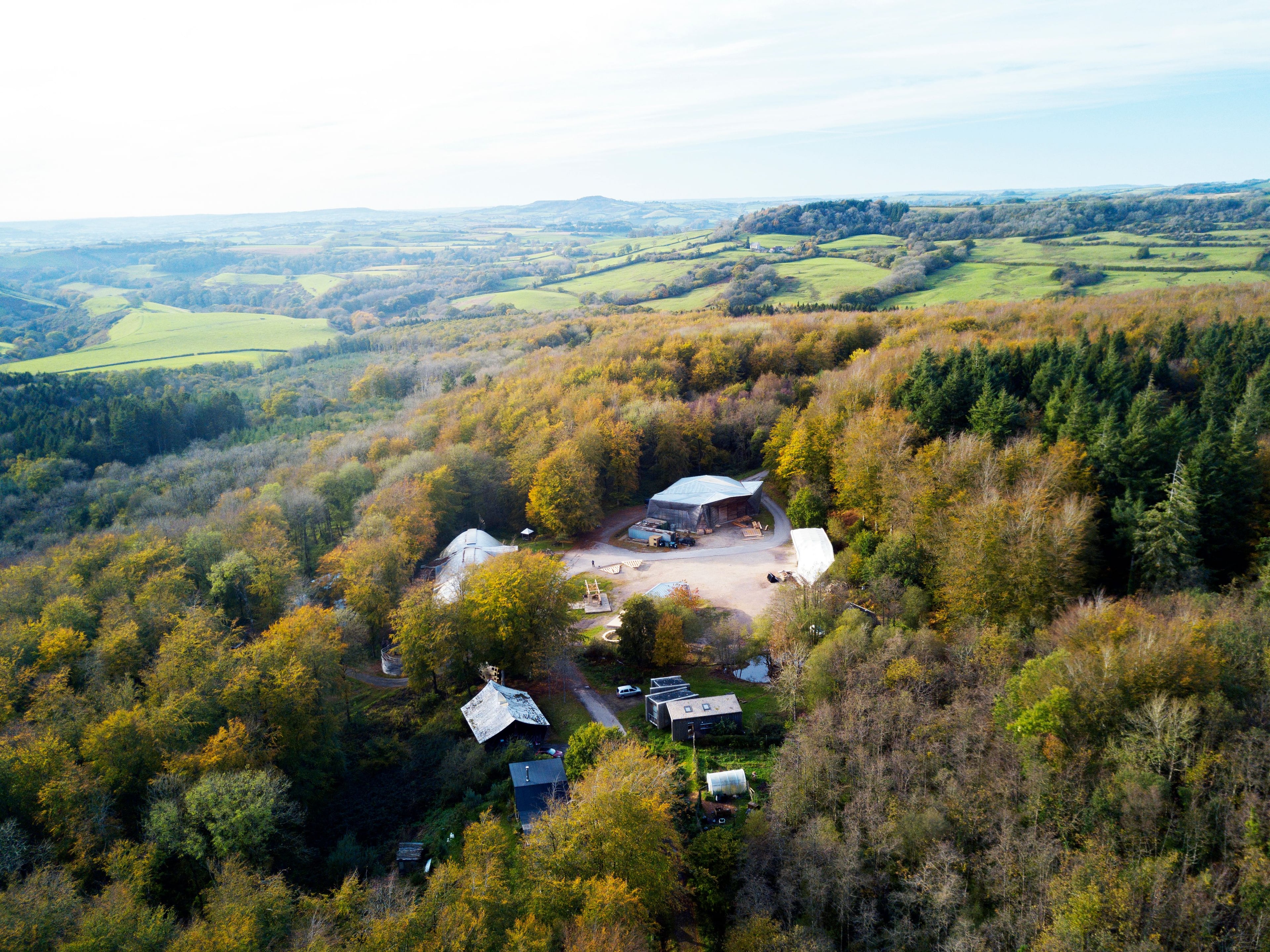 Aerial view of the Hooke Park campus within the woodland and the wider Dorset landscape