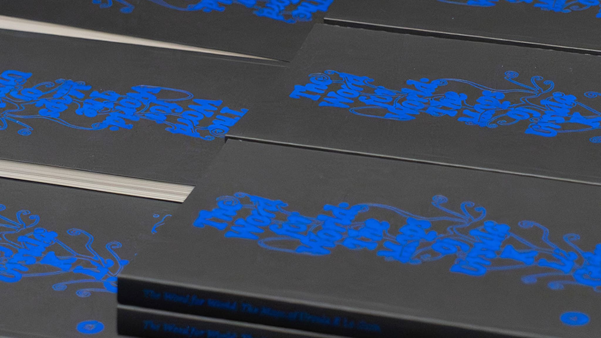 Piles of 'The Word for World: The Maps of Ursula K Le Guin' a book copublished by Silver Press and AA Publications.