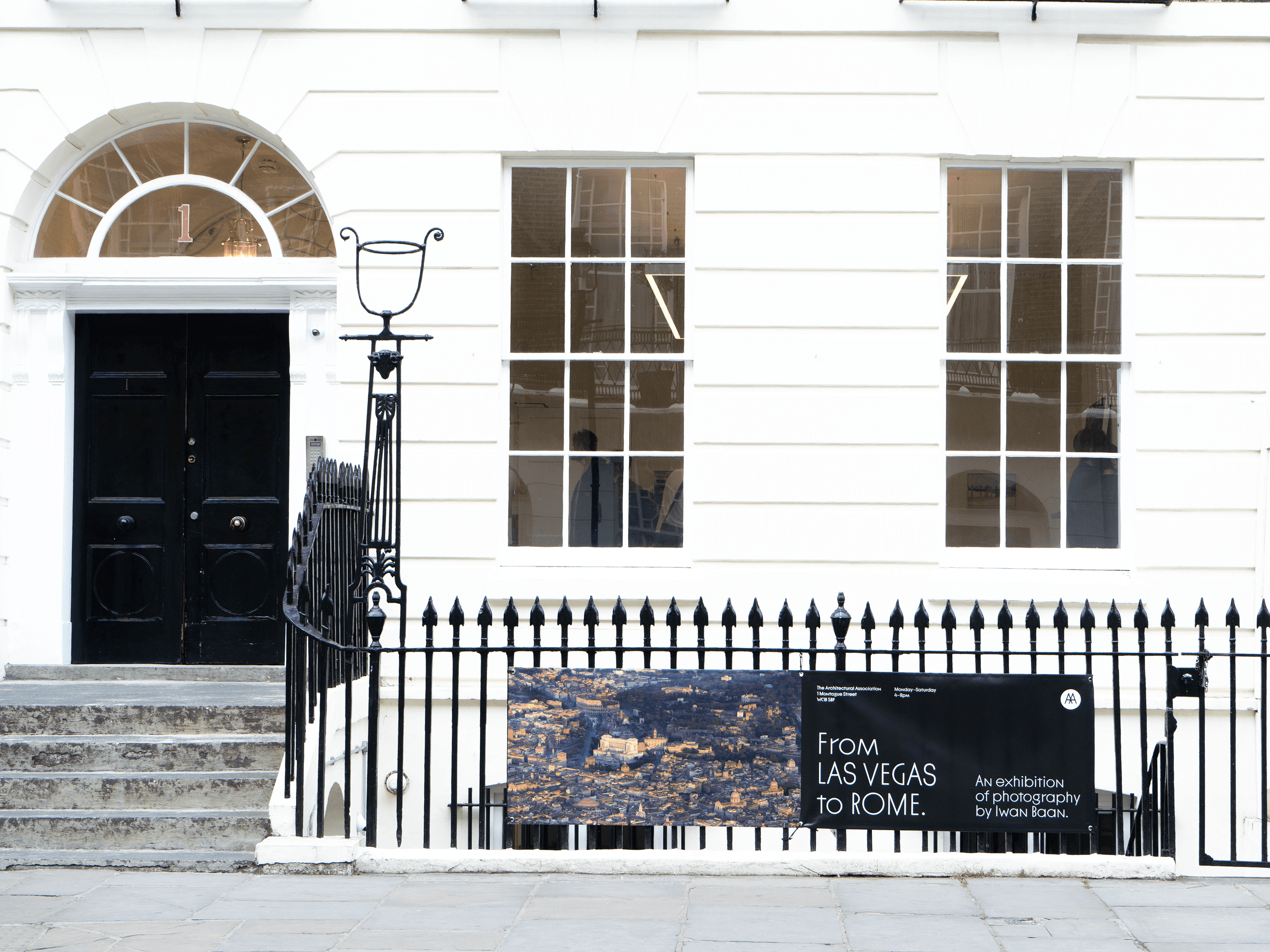 The façade of the AA's Montague Street premises, a white Georgian building with a black door, black railings and tall paned windows.